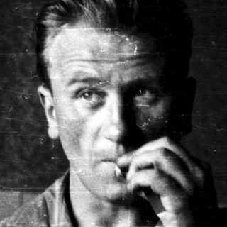 Men in dimly lit room, smoking cigarettes.