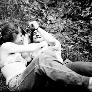 Two people and a dog resting outdoors.