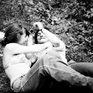 Two people and a dog resting outdoors.