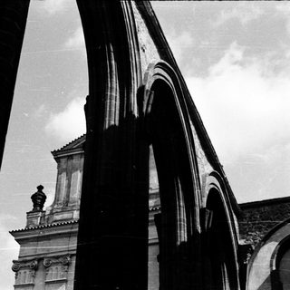 Architectural arches framing classical building facade.