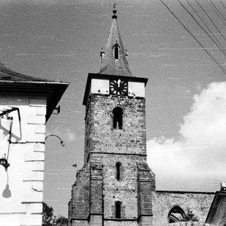 Historic stone church tower with clock.