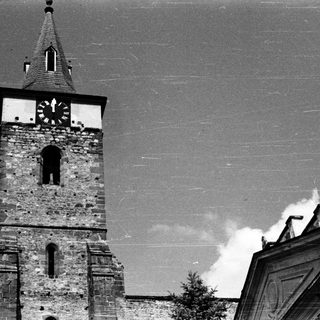 Historic stone church tower with clock.