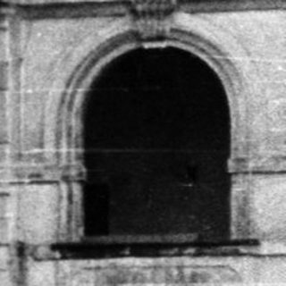 Abandoned stone building with arched ground floor.