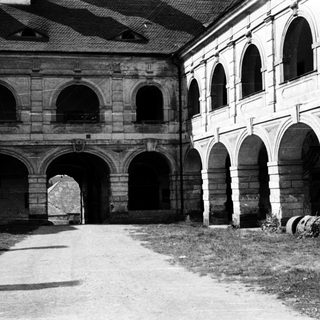 Historic courtyard with arched stone cloister.