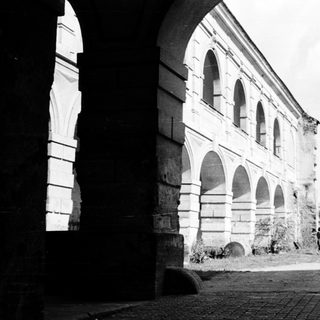 Historic stone building with arched windows and arches.