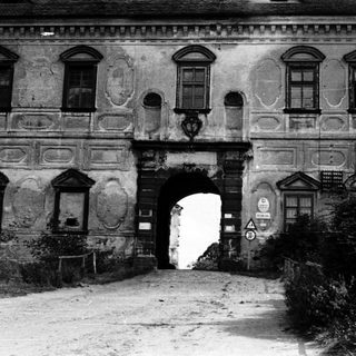 Historic gatehouse entrance with ornate, weathered facade.