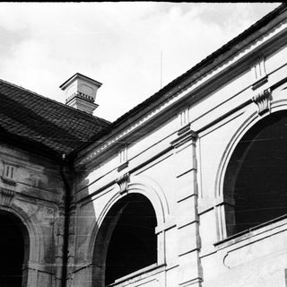 Neoclassical building facade with arched windows.