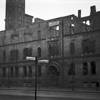 Ruined brick building with Gothic architectural elements.