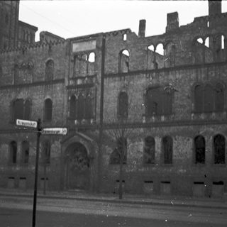 Ruined historic building facade with arched windows.