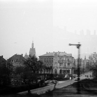 Vintage city street with historic buildings and tram.