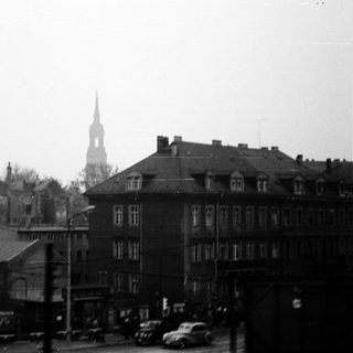 Urban street scene with historic church spire.