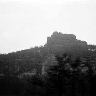 Misty mountain peak with rocky summit.