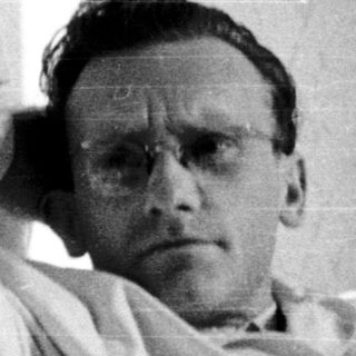 Man resting or lying in hospital gown.