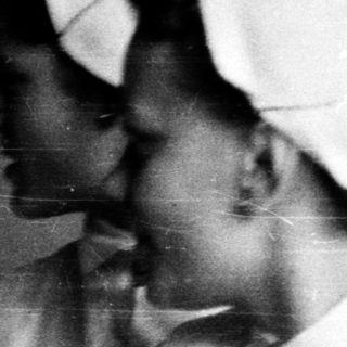 Nurses in traditional white uniforms and caps.