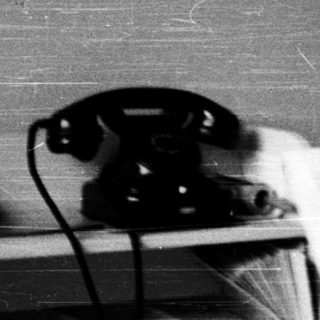 Nurse using vintage telephone in medical office.