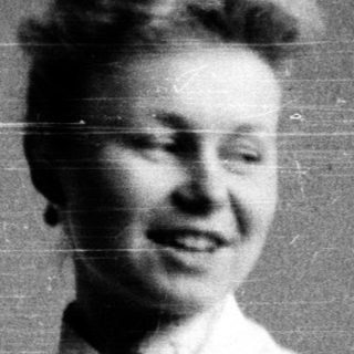 Two women in lab coats posing together, mid-20th century.