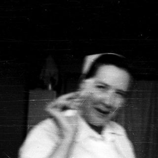 Blurred black-and-white photo of person laughing.