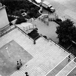 Aerial view of outdoor basketball court with players.