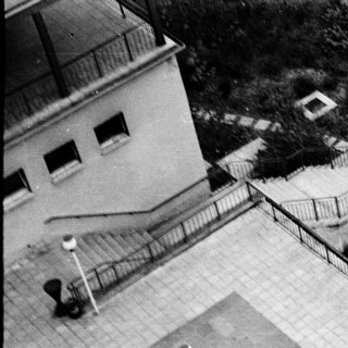 Aerial view of outdoor basketball court with players.