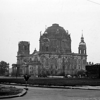 Baroque cathedral in damaged urban setting.