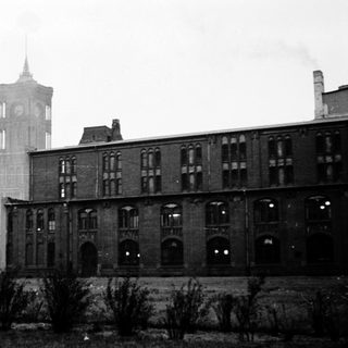 Industrial brick building with clock tower.