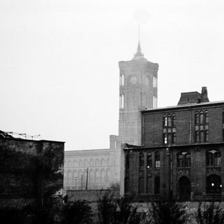 Industrial brick building with clock tower.