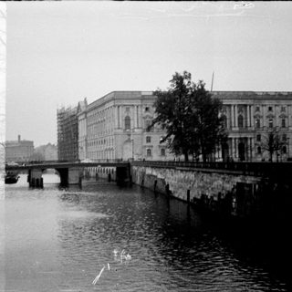 Vintage urban scene with bridge over river.