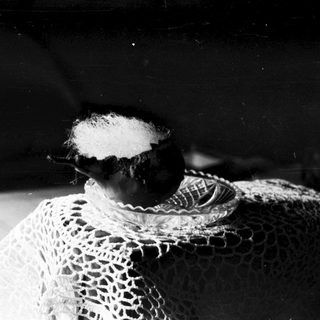 Vintage lace scarf draped over dark background.