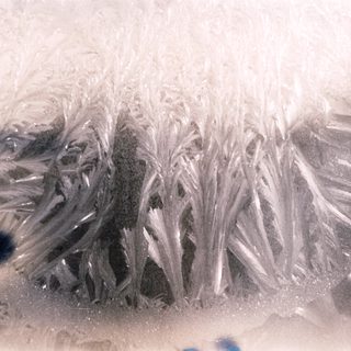 Frost patterns on a window surface.