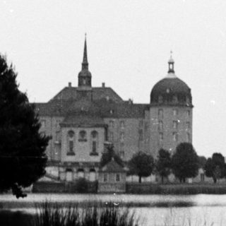 Historic castle by serene waterfront.