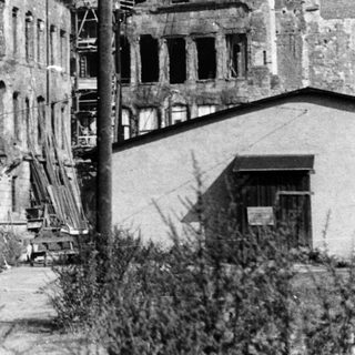 War-damaged European city buildings post-conflict.