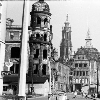 War-damaged European city with historic architecture.