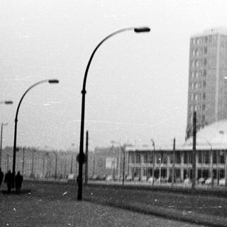 Urban street scene with tram, high-rise buildings, and snow.