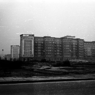 Mid-century urban apartment buildings by riverfront.