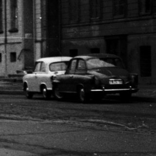 Urban street scene with pedestrian on bridge.