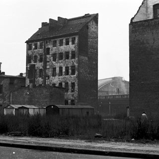 Abandoned, dilapidated multi-story buildings in urban setting.