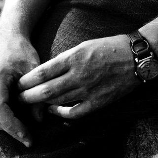 Close-up of hands clasping a wrist.