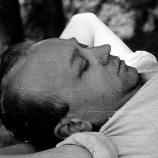 Man lying down resting outdoors.