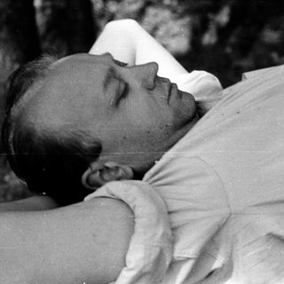 Man lying down resting outdoors.