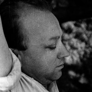 A person lying exhausted on rocky ground.