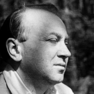 Black-and-white portrait of a man outdoors.