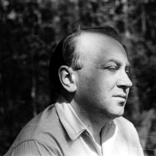 Black-and-white portrait of a man outdoors.