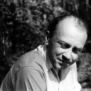 Man in outdoor setting, mid-profile, wearing light shirt.