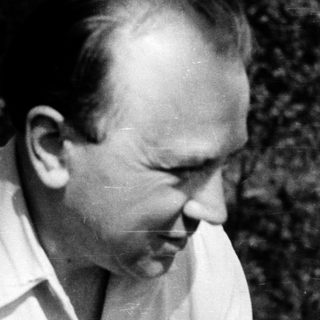 Man in outdoor setting, mid-20th century, wearing light shirt.