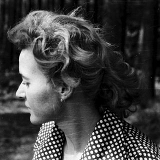 Woman with voluminous hairstyle outdoors in black-and-white.