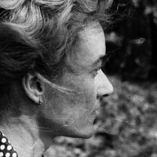 Woman in outdoor setting, mid-profile view.