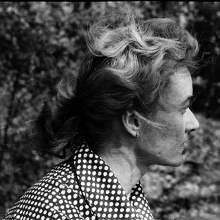 Woman in outdoor setting, mid-profile view.