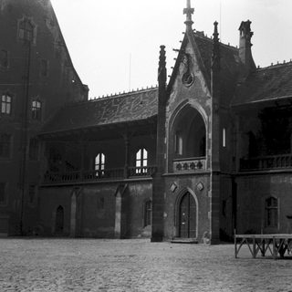 Historic castle courtyard with Gothic architecture.