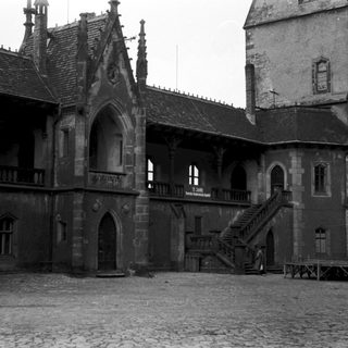 Historic stone courtyard with Gothic-style architecture.