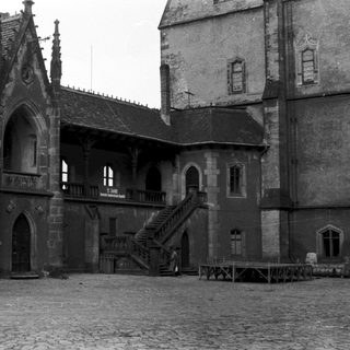 Historic stone courtyard with Gothic-style architecture.